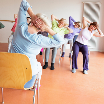 Women participating in a chair yoga class.