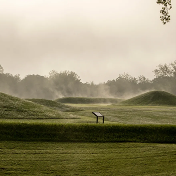 Hopewell Earthworks. A picture of the mounds of the earthwork with a plaque on the site.
