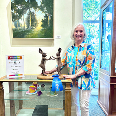 Once of the winning artists from the 2025 Senior Showcase with her sculpture.